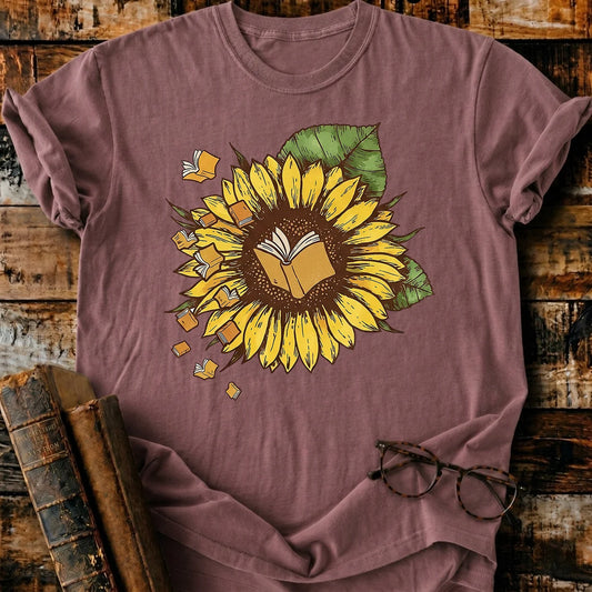Garment-dyed Comfort Colors unisex t-shirt with a sunflower and flying books design.