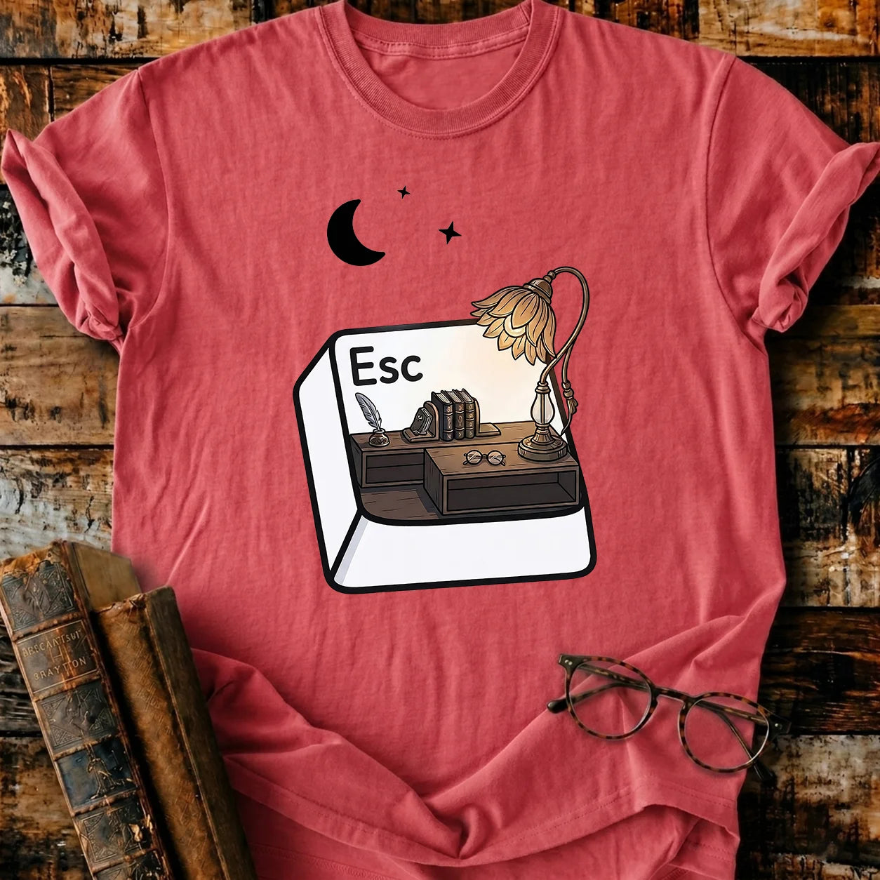 Garment-dyed red Comfort Colors Escape T-shirt with a desk, books, lamp, and moon design.